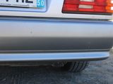 a silver car that is parked on the side of the road
