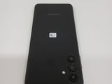 the back of a black samsung galaxy s10e phone on a white surface