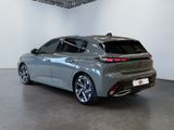 the rear view of a silver car in a showroom