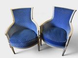 pair of blue upholstered chairs with diamond patterned upholstered cushions