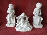 three white statues of children sitting on blocks with a red background