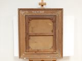 an old wooden easel with a cross on the top of it