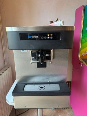 a water dispenser that is next to a pink refrigerator