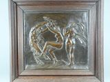 an image of a metal plaque depicting a woman and a man