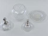 three wine glasses and a bottle on a white table