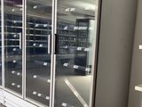 an empty refrigerator in the middle of a store