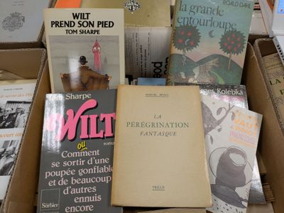 several books are stacked on top of each other in a box