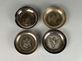 three silver metal buttons with a picture of a man and a woman on them