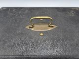 an old black suitcase with a handle on it