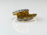 an image of a yellow and white diamond ring on a white surface