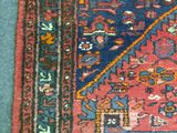 rug on the floor is red and blue with a design on it