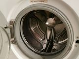 a washing machine that is sitting in a room