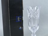 a wine glass sitting next to a box on a table