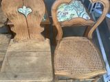 two wooden chairs that are sitting next to each other