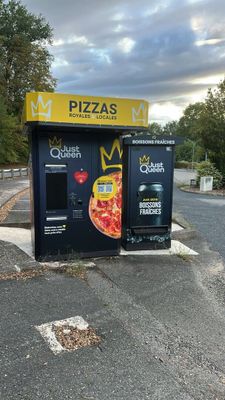 a vending machine that has a pizza on the front of it