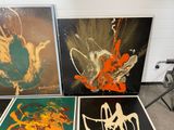 three paintings of different colors and sizes are on display in a room