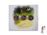 a picture of a book with a picture of a tree and three coins