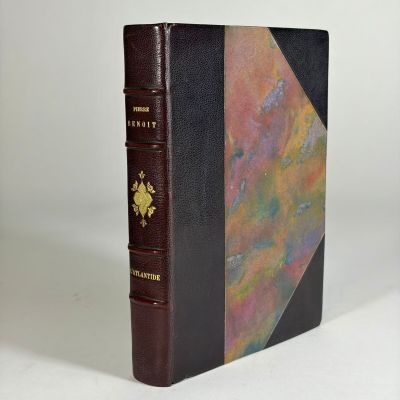 an old book with a brown cover and a black binding