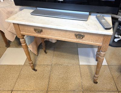 a television sitting on top of a table with a remote on it