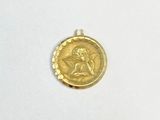 une image représentant une pièce d'or sur laquelle figure le portrait d'une femme