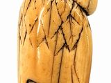 a small wooden object with a face on it
