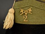 a green uniform with two crossed arrows and a tassel on it