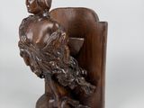 an image of a statue of a woman sitting in a chair