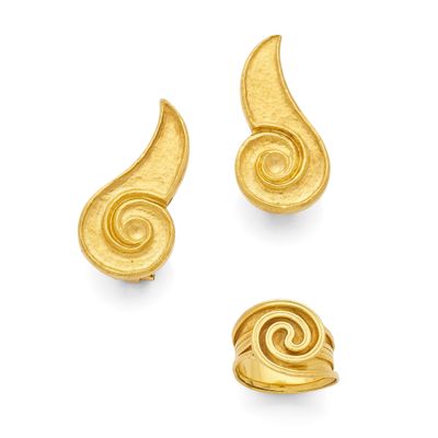 a set of three gold earrings with swirl designs