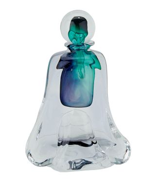 a glass bell with a green figure inside of it