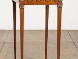 a small table with a drawer on it on a wooden floor