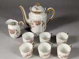 six cups and a teapot on the table