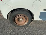 a white car that has a flat tire on it