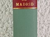 a green book sitting on a table next to a white wall