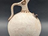 a white vase with a bird on it on a black background