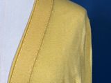 a close up of a mannequin torso wearing a yellow cardigan