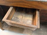 a wooden drawer that is open on the floor
