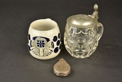 a small glass jar with a lid next to a small glass jar