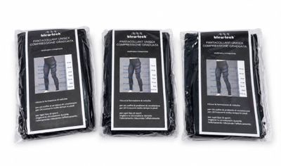 three pairs of black pants in plastic bags on a white surface