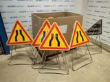 three warning signs on the ground next to a cardboard box
