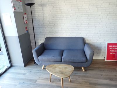 a couch and a table in a room with a brick wall