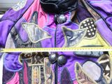 a purple jacket with a design on it and a measuring tape in front of it