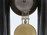 a black and gold clock sitting on top of a table