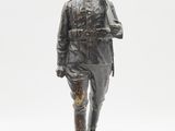 statue of a man in a military uniform holding a rifle