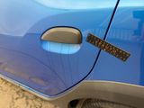 a sticker on the door of a blue car