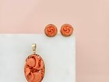 an image of a necklace and earring set on a marble surface