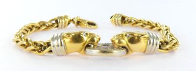 a close up of a gold bracelet with two elephants on it