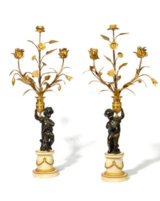 pair of antique bronze and marble candlesticks with cherenshes and flowers