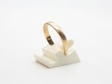 a gold ring sitting on top of a white marble block