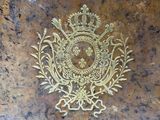 an image of a gold emblem on a marble surface