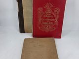 two old books sitting on top of a table next to each other